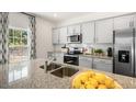 Modern kitchen with granite countertops and stainless steel appliances at 6461 Alfalfa Ln, Wake Forest, NC 27587