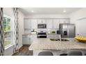 Modern kitchen featuring granite countertops and stainless steel appliances at 6461 Alfalfa Ln, Wake Forest, NC 27587