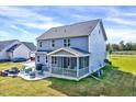 Home's back elevation showcasing screened porch and patio at 798 Christian Light Rd, Fuquay Varina, NC 27526