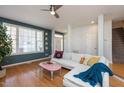 Living room with hardwood floors, white sectional sofa, and a pink coffee table at 8010 Mackenzie Ct, Durham, NC 27713