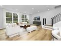 Bright and airy living room with hardwood floors and large windows at 917 Myers Point Dr # 21, Morrisville, NC 27560