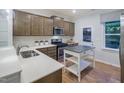 L-shaped kitchen with stainless steel appliances and white quartz countertops at 1011 Freestone Rd, Durham, NC 27703