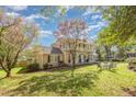Two-story home showcasing a well-manicured lawn and lush trees at 110 E Orange St, Hillsborough, NC 27278