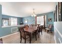 Elegant dining room with seating for eight, natural light at 112 Smith Rock Dr, Holly Springs, NC 27540