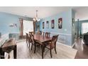 Formal dining room featuring a wood table, blue walls, and large window at 112 Smith Rock Dr, Holly Springs, NC 27540