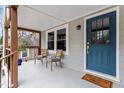 Inviting front porch with seating area, stylish blue front door, and 'Home Sweet Home' welcome mat at 1606 James St, Durham, NC 27707