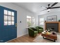 Bright living room featuring a ceiling fan, fireplace, hardwood floors, and stylish furnishings at 1606 James St, Durham, NC 27707