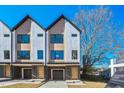 Modern townhouses, two-car garages, and a tree in front at 2119 Brewer St, Raleigh, NC 27608