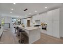 Modern white kitchen with large island and stainless steel appliances at 2119 Brewer St, Raleigh, NC 27608