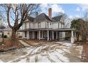 Two-story home with a wraparound porch and large yard at 228 S Fayetteville St, Liberty, NC 27298