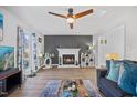 Living room features a fireplace, hardwood floors, and a ceiling fan at 2408 Cynthia Dr, Durham, NC 27704