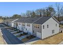 Rear view of townhouses showcasing attached garages at 316 Church St # 38, Wendell, NC 27591