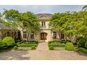 An attractive, luxury home with a manicured lawn and brick driveway offers great curb appeal at 32602 Archdale, Chapel Hill, NC 27517