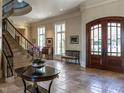 Spacious foyer with stone floors, grand staircase, and custom wood doors is ideal for entertaining at 32602 Archdale, Chapel Hill, NC 27517