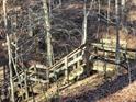 Wooden staircase leading down a wooded hillside at 3722 Durham Rd, Raleigh, NC 27614