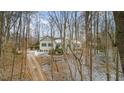 House exterior view showing a driveway and surrounding trees at 4132 Mountainbrook Rd, Apex, NC 27539