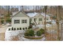 A light gray house with a front door and landscaping in the winter at 4132 Mountainbrook Rd, Apex, NC 27539