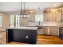 Kitchen boasts stainless steel sink, quartz countertops, and ample cabinet space at 4860 Fayetteville Rd, Durham, NC 27713