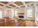 Living room features hardwood floors, fireplace, and large windows at 4860 Fayetteville Rd, Durham, NC 27713