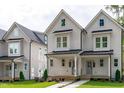 Charming two-story home featuring a welcoming front porch, fresh grass, and modern curb appeal at 5041 Lundy Dr # 101, Raleigh, NC 27606