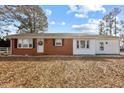 Charming brick and siding home with a welcoming front entrance and well-maintained lawn and driveway at 5088 Christian Light Rd, Fuquay Varina, NC 27526
