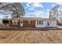 Quaint single-story home boasts brick and white siding, complemented by a lawn and a welcoming front entrance at 5088 Christian Light Rd, Fuquay Varina, NC 27526