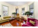 Spacious living room with hardwood floors, large windows, and comfortable seating at 517 N East St, Raleigh, NC 27604