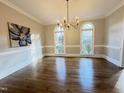 Bright dining room with hardwood floors and large windows at 704 Misty Isle Pl, Raleigh, NC 27615