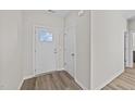 Front entry with white door and wood-look flooring at 75 Brookhaven Dr, Spring Hope, NC 27882