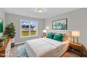 Bright bedroom featuring a cozy bed with a large window overlooking a beautiful green lawn at 8 Looping Horse Cir, Angier, NC 27501