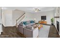 Inviting living room with a comfortable gray sofa, modern decor, and hardwood floors creates a warm atmosphere at 8 Looping Horse Cir, Angier, NC 27501