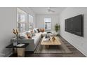 Bright living room with a modern sectional, and large windows at 819 Cumberland St, Raleigh, NC 27610
