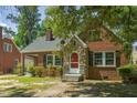 Brick house with stone accents, red door, and landscaped yard at 945 Sycamore St, Rocky Mount, NC 27801