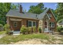 Brick house with stone accents, covered porch, and mature trees at 945 Sycamore St, Rocky Mount, NC 27801