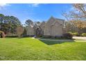 Expansive front lawn leading to a stately brick home, complemented by mature trees, professional landscaping, and great curb appeal at 101 Bonica Creek Dr, Garner, NC 27529