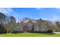 Beautiful brick home on a well-manicured lawn with mature landscaping at 101 Bonica Creek Dr, Garner, NC 27529
