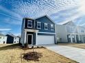 Two-story house with blue siding, white garage door, and landscaping at 110 Gabriel Ct, Clayton, NC 27520
