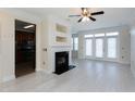 Living room with fireplace, hardwood floors, and access to kitchen at 1401 Coopershill Dr # 211, Raleigh, NC 27604