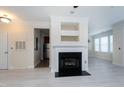 Living room with fireplace, hardwood floors, and access to kitchen at 1401 Coopershill Dr # 211, Raleigh, NC 27604