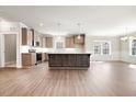 Modern kitchen with an island, stainless steel appliances, ample cabinet space, and stylish pendant lighting at 1975 Meadowview Dr, Graham, NC 27253