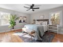Bright bedroom featuring hardwood floors, a ceiling fan, neutral walls, and coordinated decor at 3305 Victor Pl, Raleigh, NC 27604