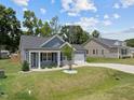 Gray house next to tan house with green lawn at 36 Mae Ct, Roxboro, NC 27573