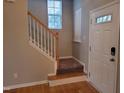 Welcoming entryway features wood floors, staircase and a white front door with sidelight at 4202 Cherry Blossom Cir, Durham, NC 27713