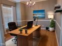 Bright office space with wood floors, large desk, stylish decor, and natural light at 4202 Cherry Blossom Cir, Durham, NC 27713