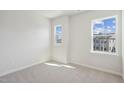 Well lit bedroom with two windows offering neighborhood views at 4717 Cypress Tree Ln, Raleigh, NC 27612