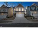 Two-story home with neutral siding, two-car garage, illuminated at night at 501 Hanover Shore Ln, Raleigh, NC 27610