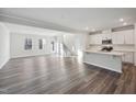 Modern kitchen featuring white cabinetry, stainless steel appliances, and an island at 501 Hanover Shore Ln, Raleigh, NC 27610