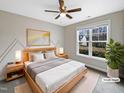 Virtually staged bedroom with light wood furniture and large window at 55 Oxer Dr, Youngsville, NC 27596