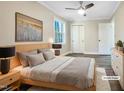 Virtually staged bedroom with a queen bed, wood floors, and neutral walls at 6307 Tryon Rd, Cary, NC 27518