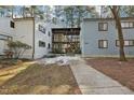 Attractive condo building with covered walkways, exterior stairs and mature trees surrounded by a well-kept lawn at 642 Pine Ridge Pl, Raleigh, NC 27609